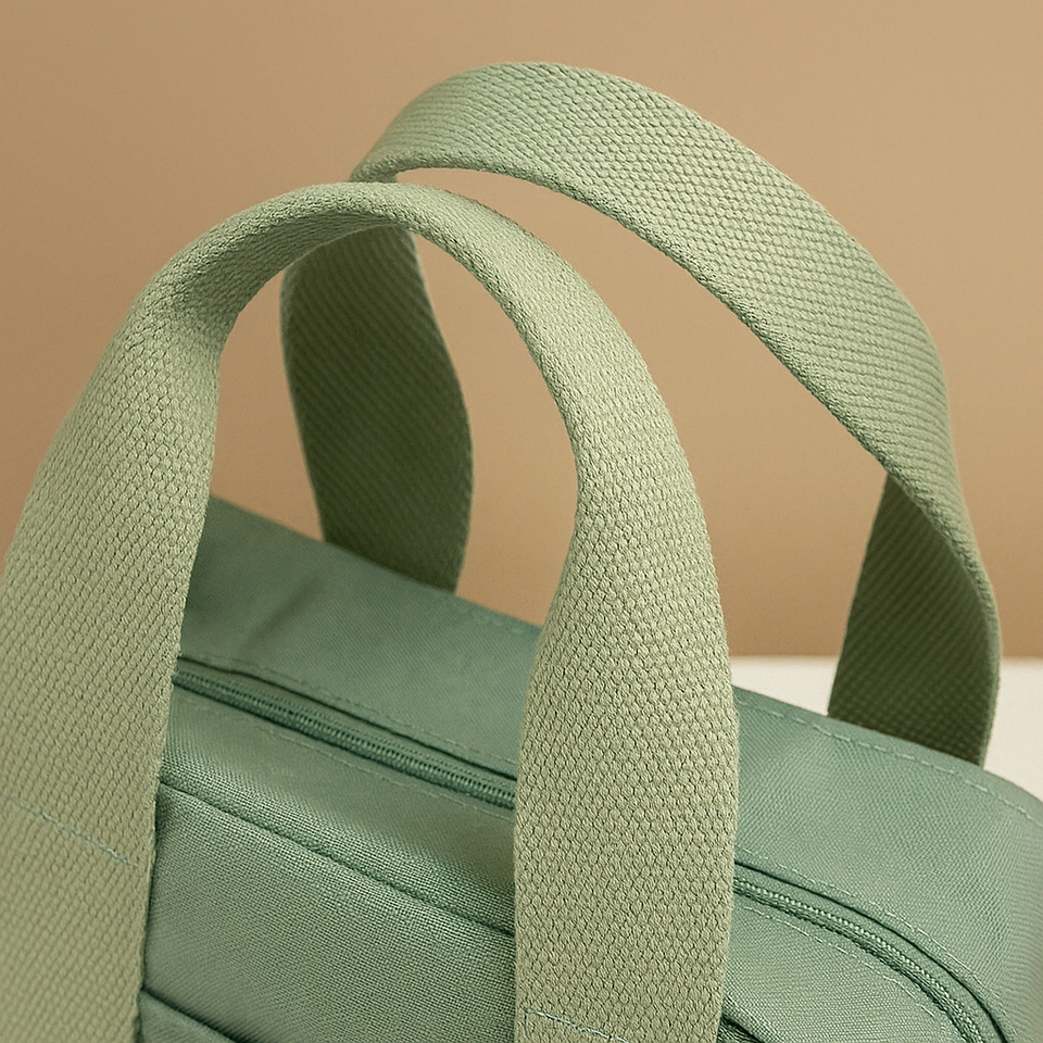 Canvas shoulder bag with multiple compartments for women.