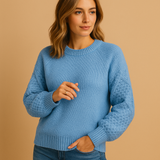 Knitted women's sweater with round neck.