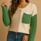 Knitted women's sweater with cable pattern and pocket detail.