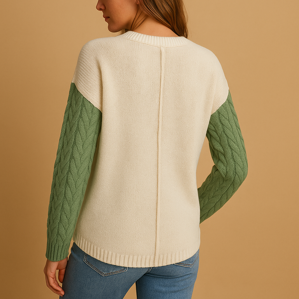 Knitted women's sweater with cable pattern and pocket detail.