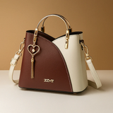 Shoulder bag with geometric pattern and adjustable strap for women.