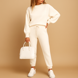Two-piece women's tracksuit with a high collar and elastic waist.