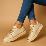 White sneakers with gold detailing for women